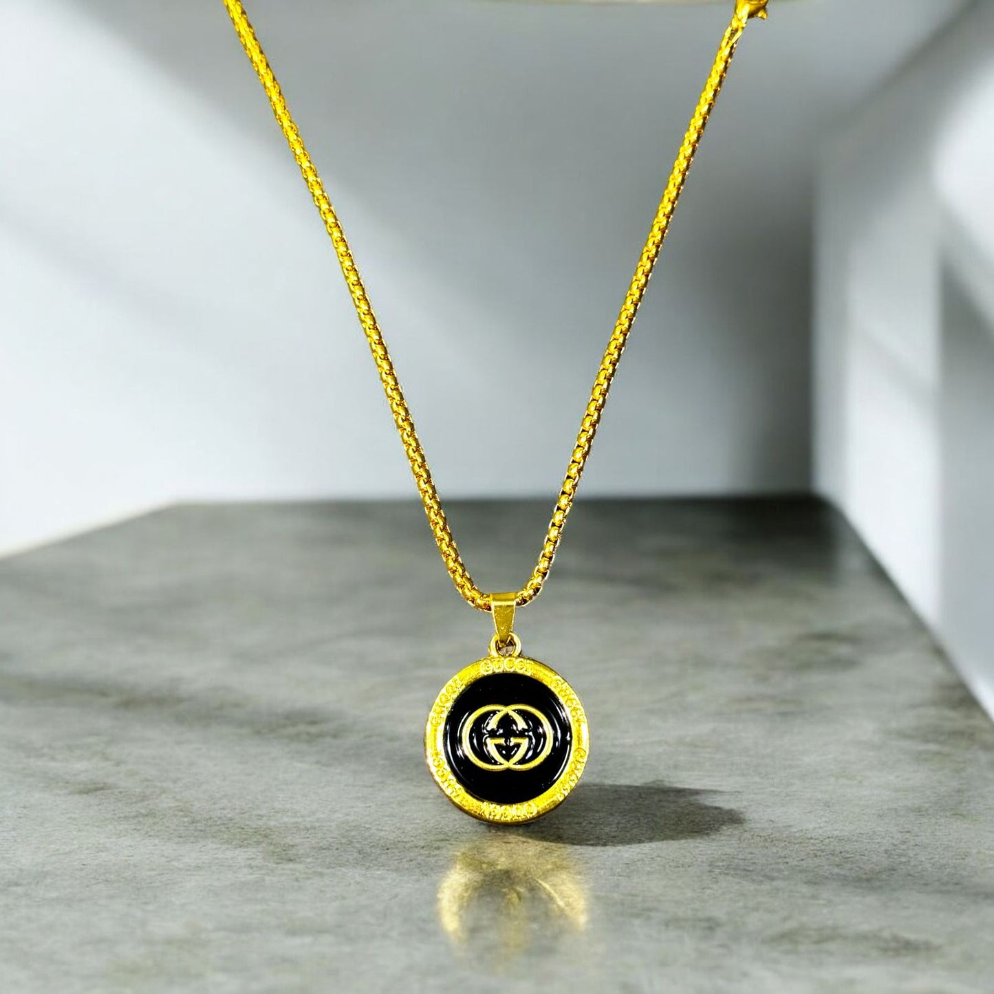 Gucci Gold and Black Pendant